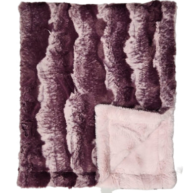 Fluffy purple and pink textured blanket on a light gray background