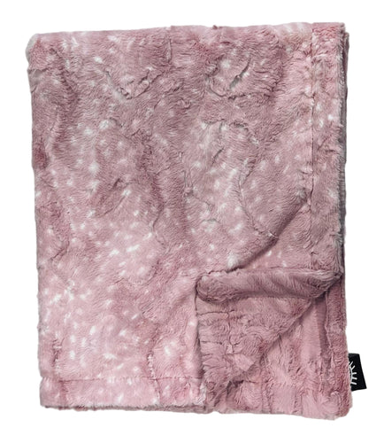 Pink textured blanket on a light gray background